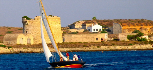 Vista dels velers entrant al port de Mahn i passant enfront de la bateria militar de la mola